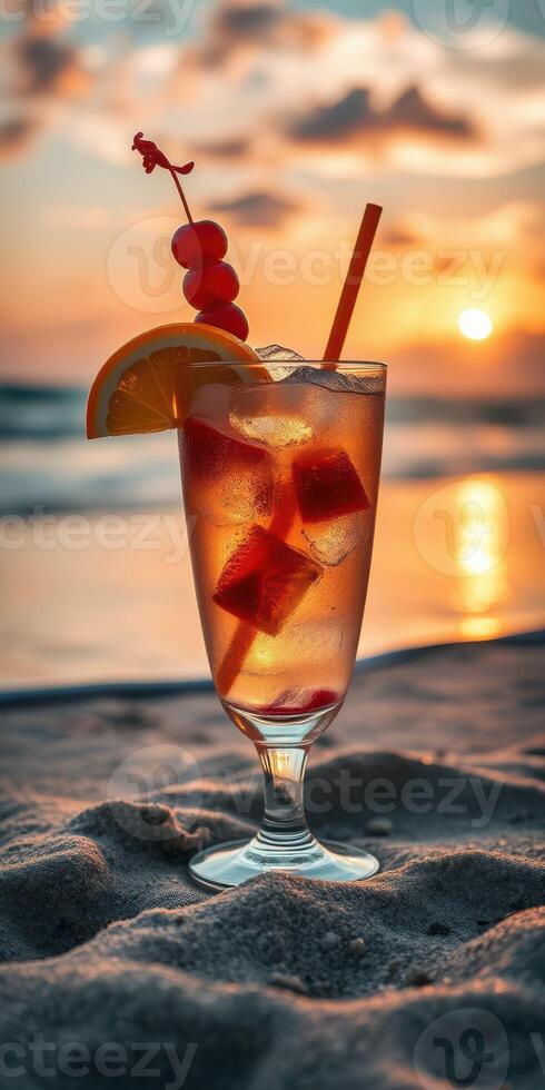 Sunset beach cocktail with fruit garnish against a vibrant sky and ocean photo