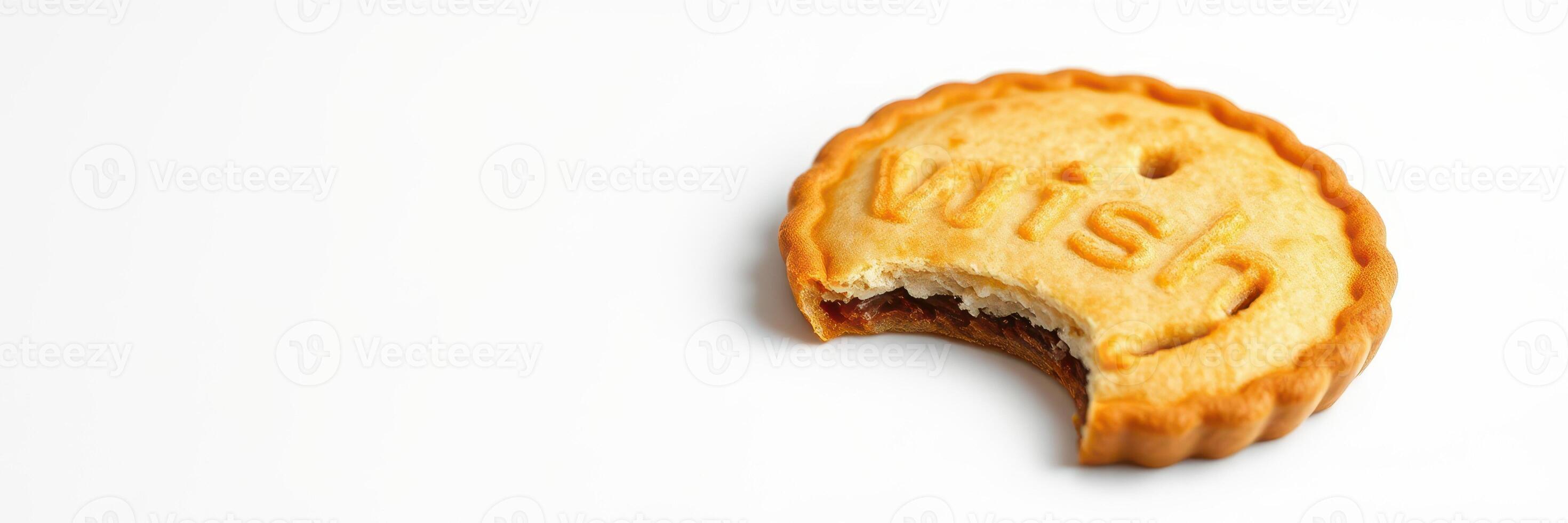 Bite-sized cookie with wish engraved on its surface rests against a plain background photo