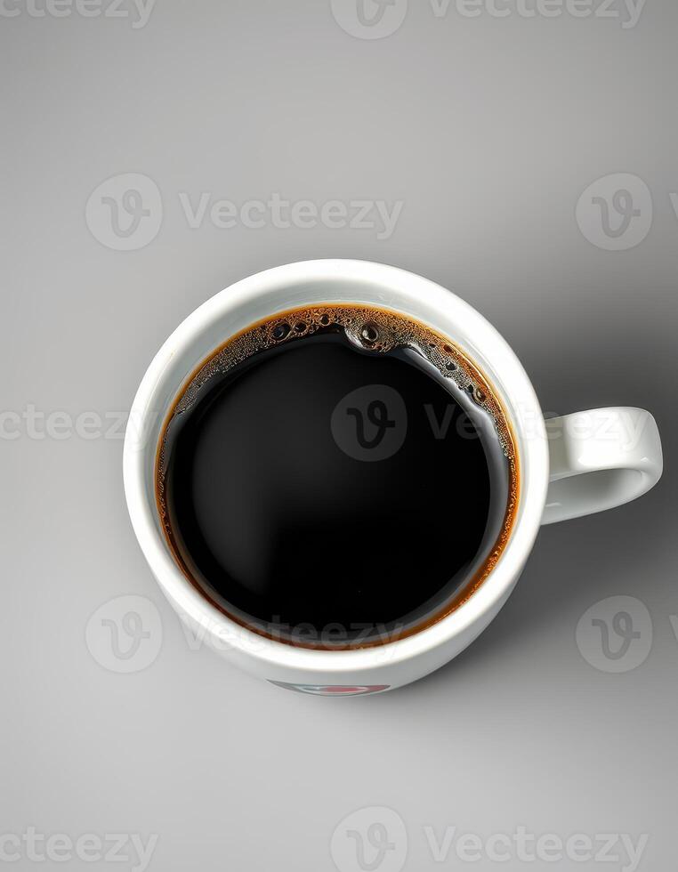 Freshly brewed black coffee in a white mug on a simple gray surface during morning hours photo