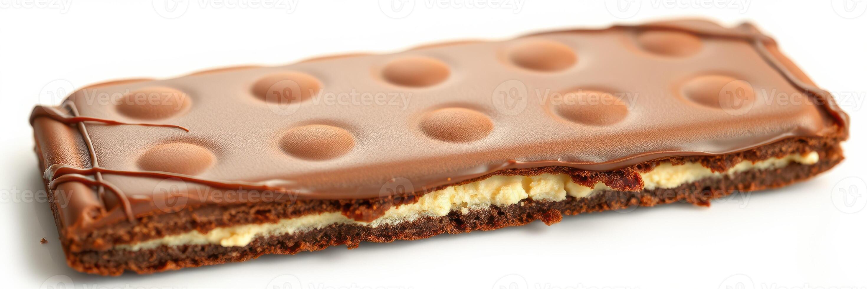 Chocolate bar with creamy filling and textured surface displayed on white background photo
