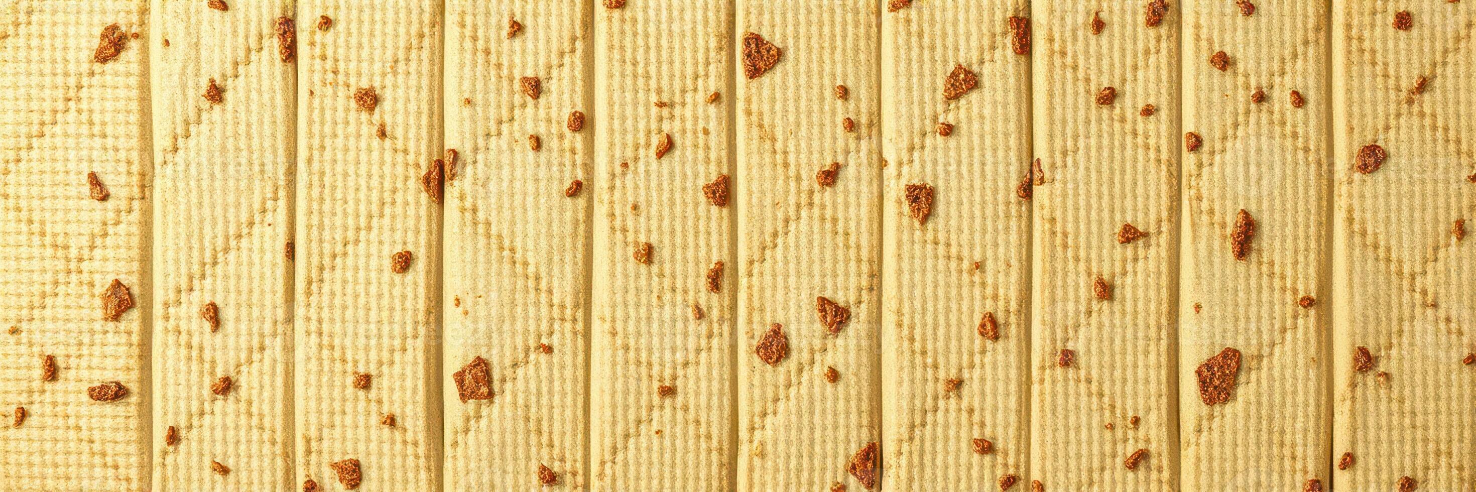 Textured surface with brown blemishes on a light golden background illustrating natural design detail photo