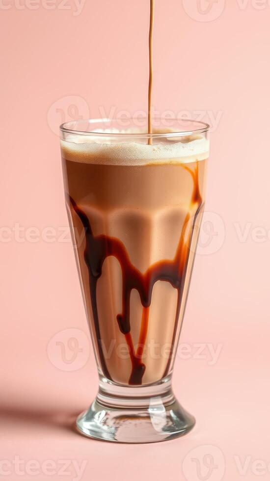 Smooth and creamy beverage with chocolate drizzle on light pink background photo