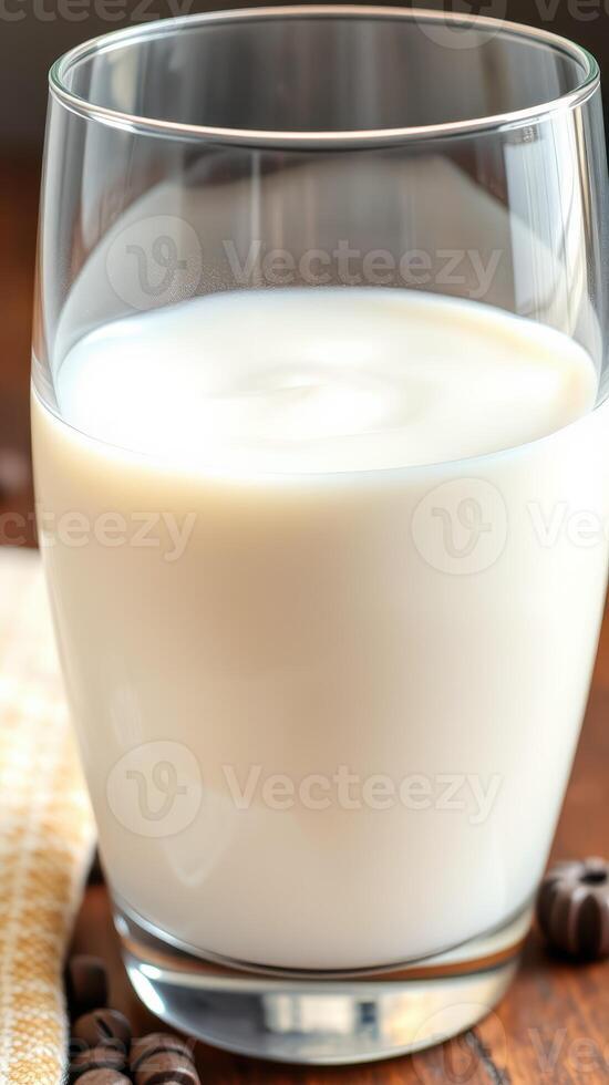 Refreshing glass of milk served on a wooden table with decorative coffee beans and a cloth napkin photo