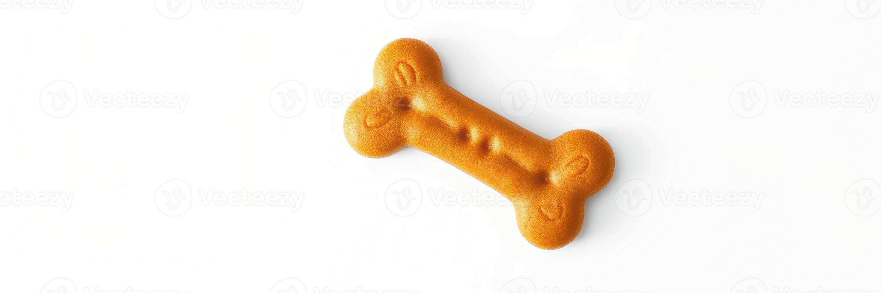 Dog treat shaped like a bone on a white background ready for pet enjoyment and training purposes photo