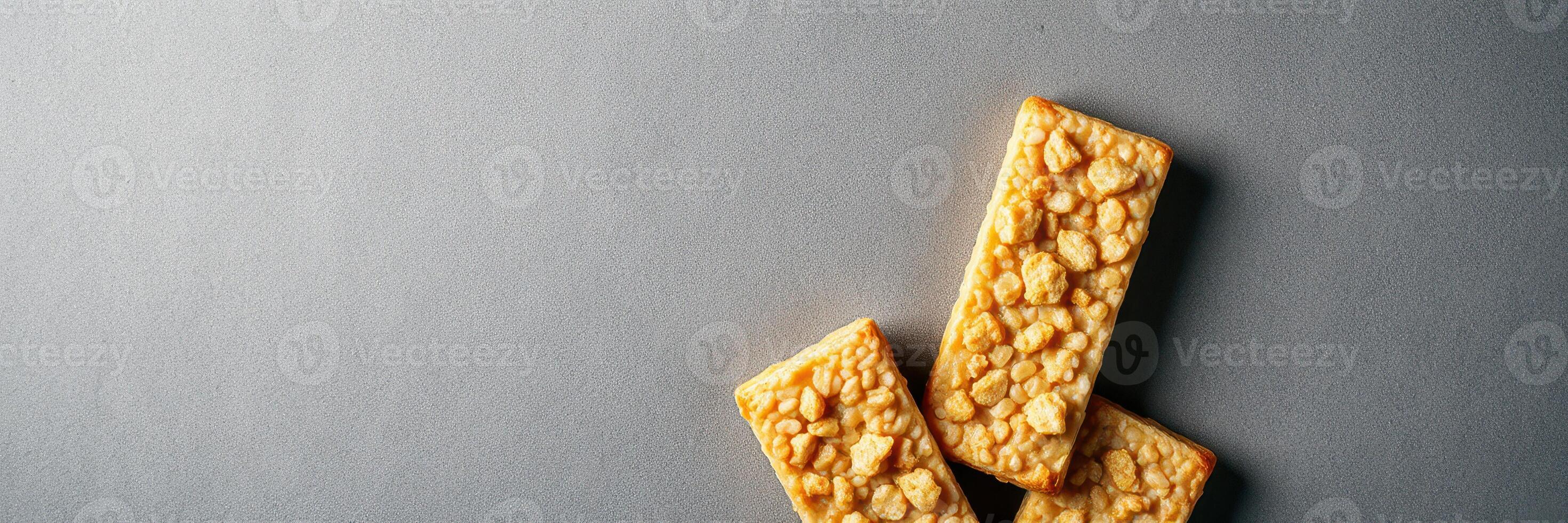Crunchy rice bars arranged on a gray surface, showcasing their texture and enticing appearance for snack enthusiasts photo