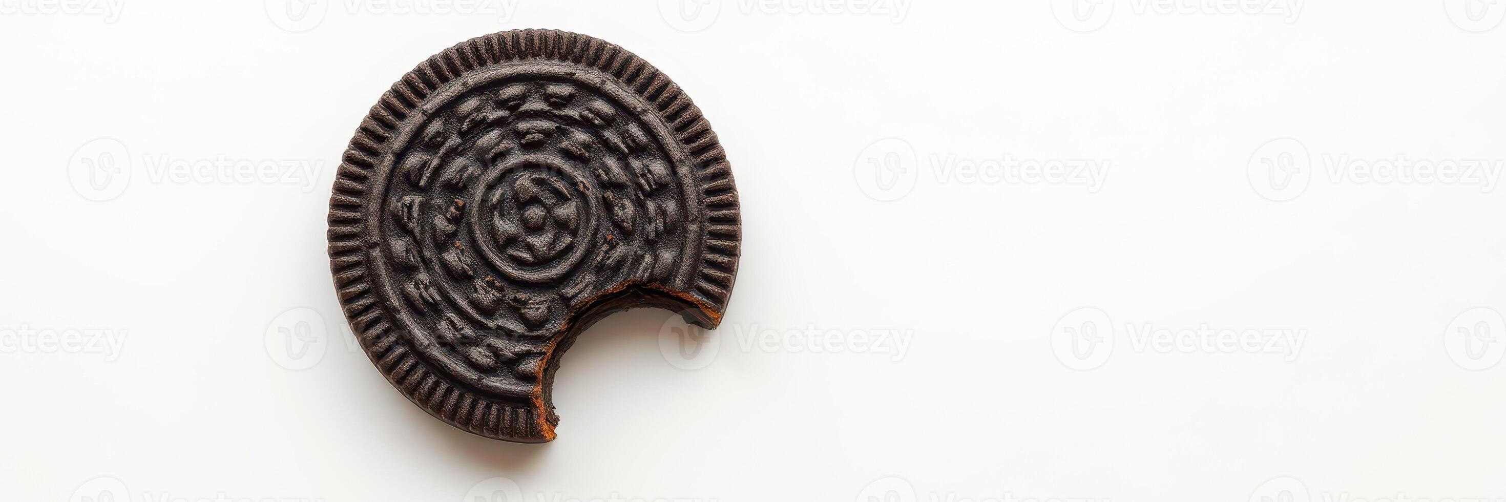 Broken chocolate cookie with intricate design on a light background photo