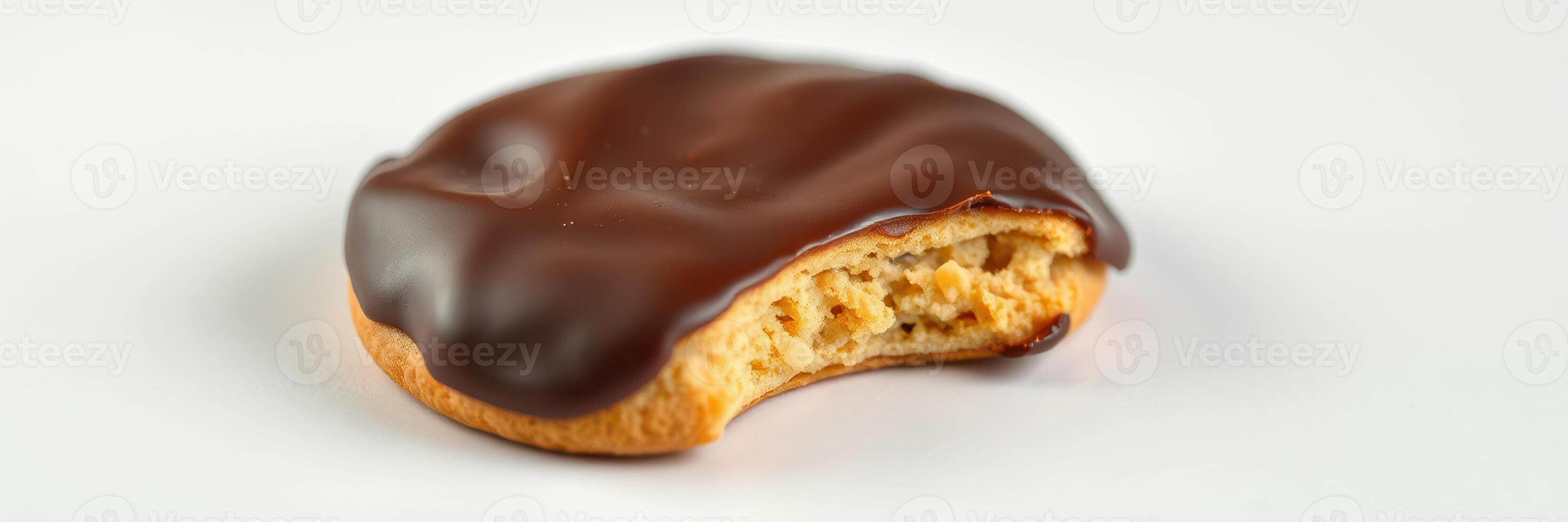 Chocolate covered cookie with a bite taken out, revealing a soft filling, perfect for dessert lovers photo