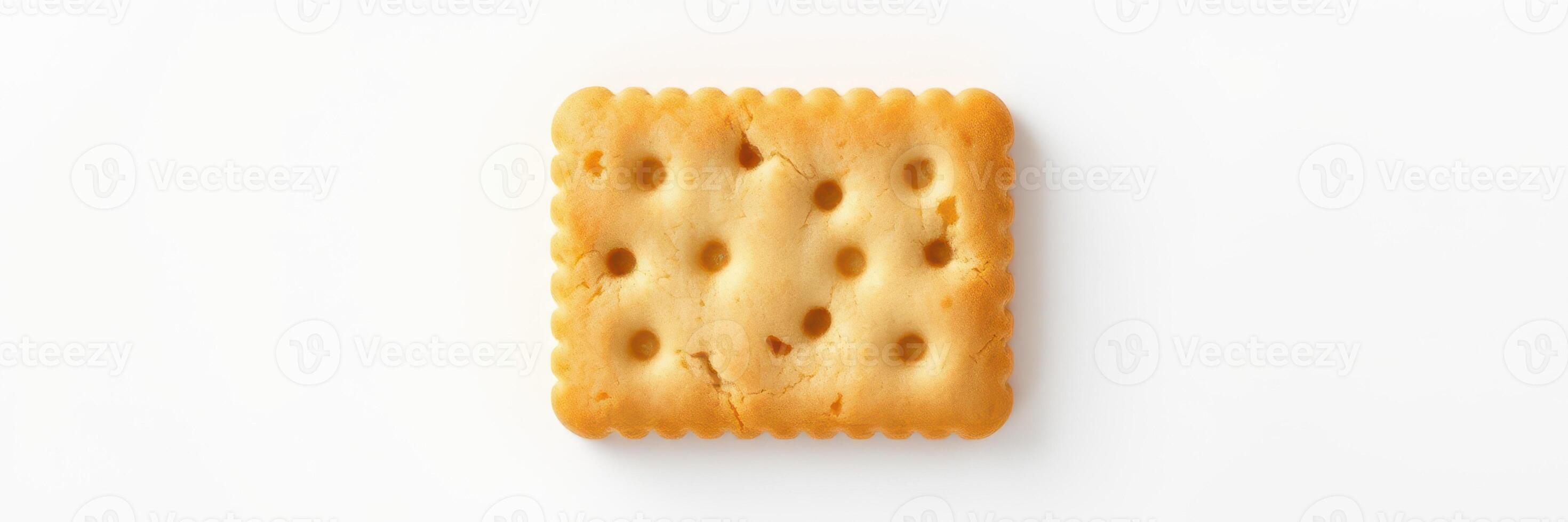 Simple biscuit placed on a clean white surface highlighting the texture and color, perfect for snacks or desserts photo