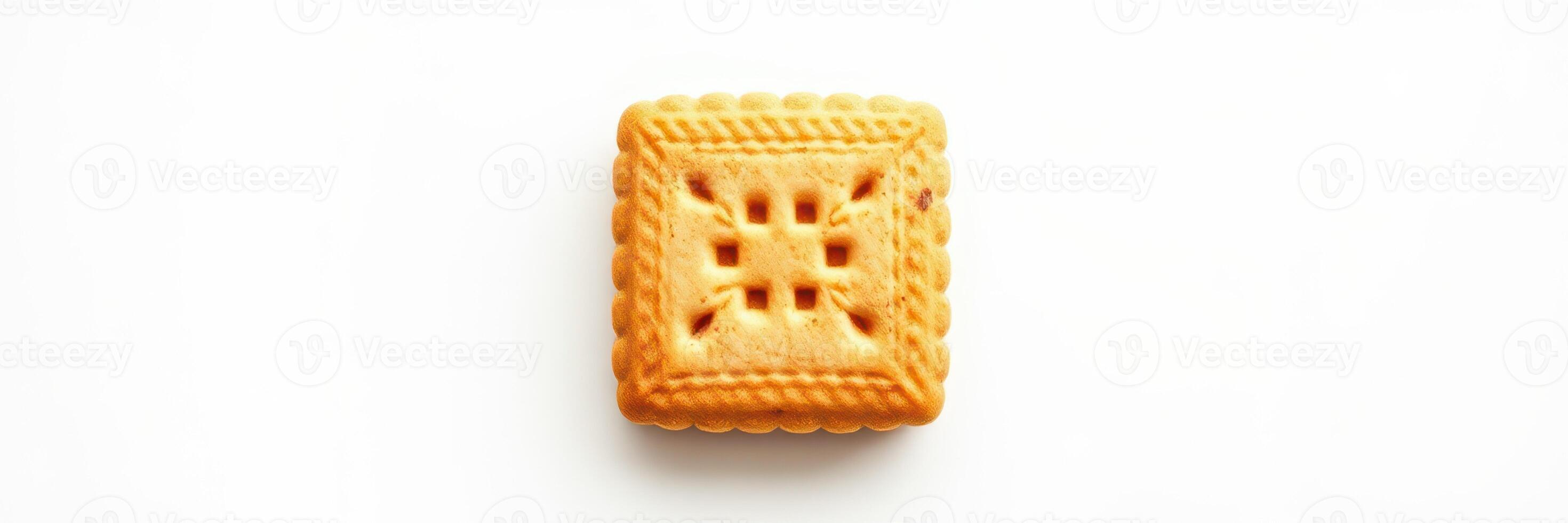 Crispy golden square biscuit with intricate pattern on a white background photo