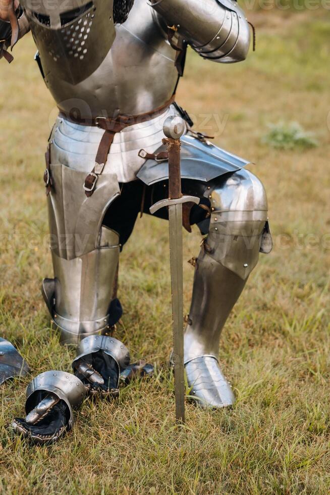 Close-up of a medieval knight in armor preparing for battle photo