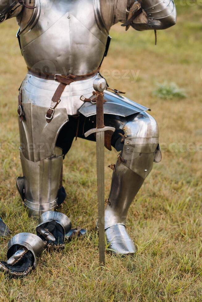 Close-up of a medieval knight in armor preparing for battle photo