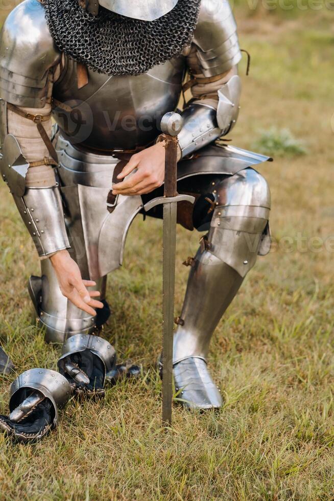 Close-up of a medieval knight in armor preparing for battle photo