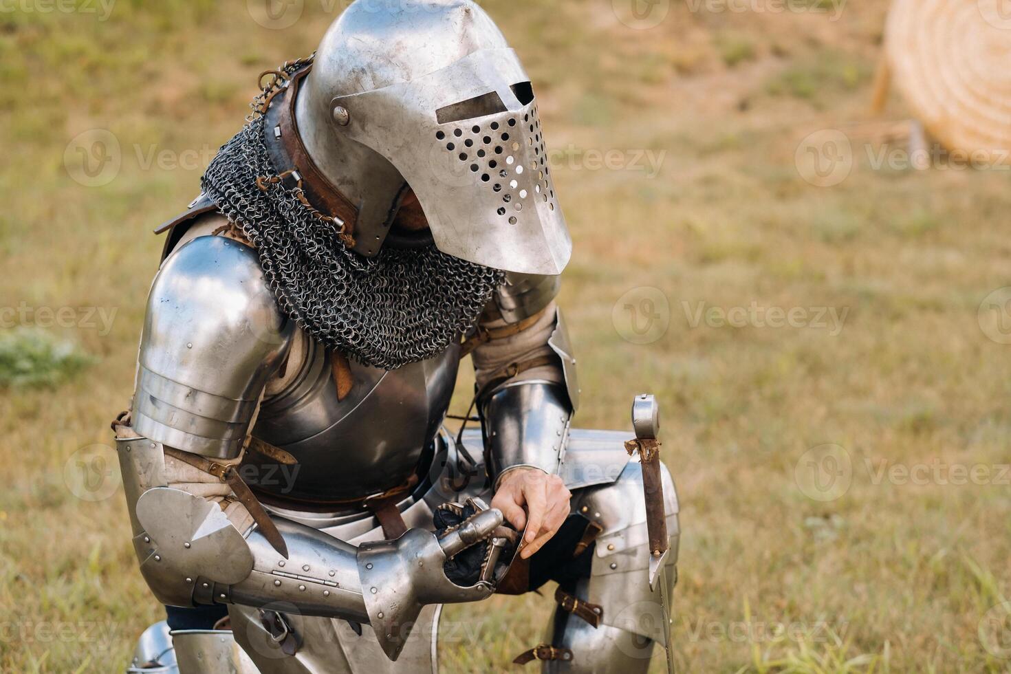 Close-up of a medieval knight in armor preparing for battle photo