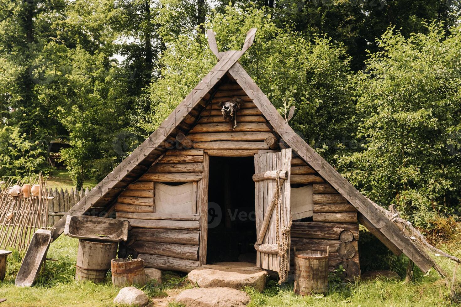 Triangular log houses with wooden roofs behind a fence. Montenegro, north photo