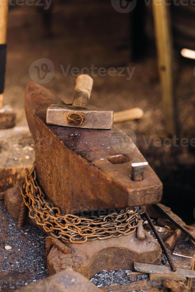 Forge, hammer on an anvil standing on the street photo