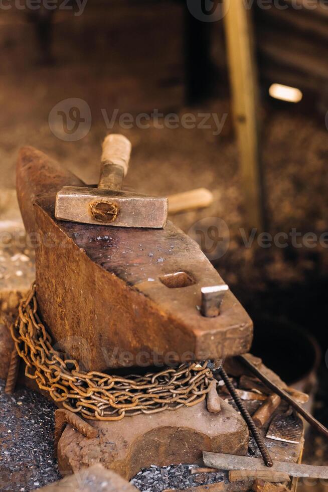 Forge, hammer on an anvil standing on the street photo