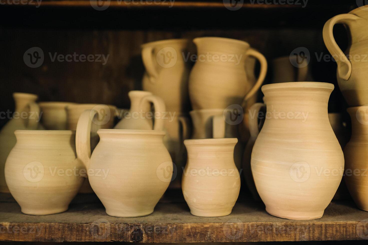 Ceramic clay jugs standing on a shelf in the village photo