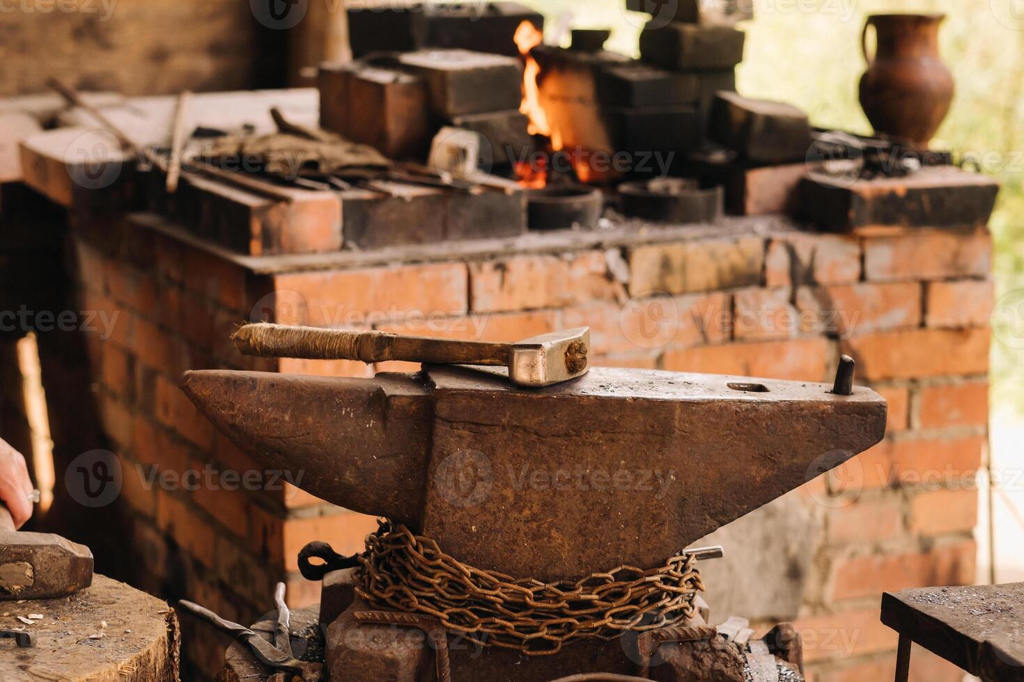 Forge, hammer on an anvil standing on the street photo