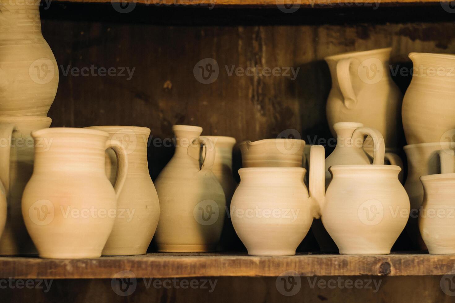 Ceramic clay jugs standing on a shelf in the village photo