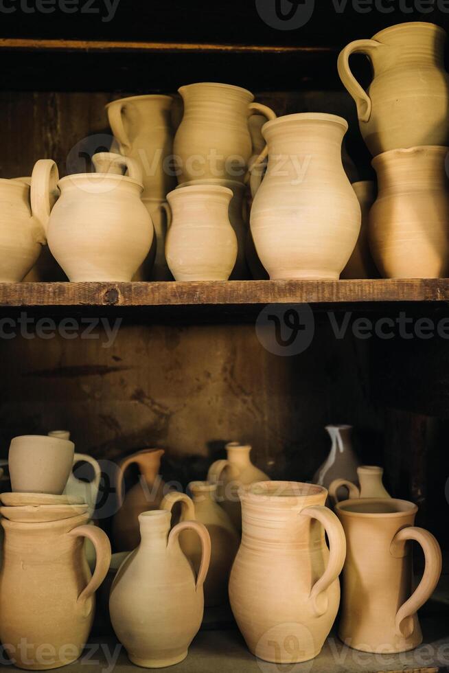 Ceramic clay jugs standing on a shelf in the village photo