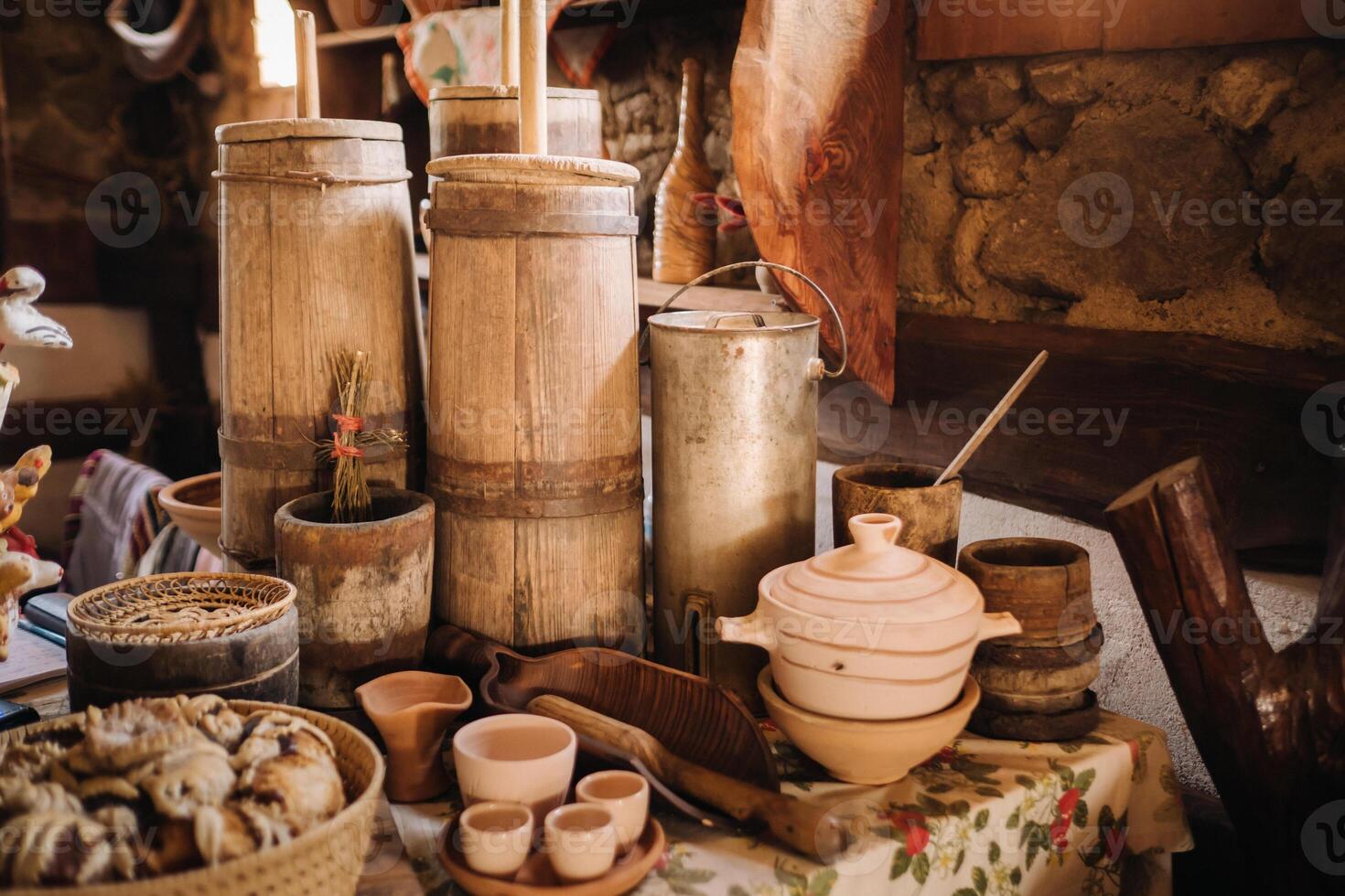 Old wooden barrels and dishes on the table in the village. Rustic antique tableware photo