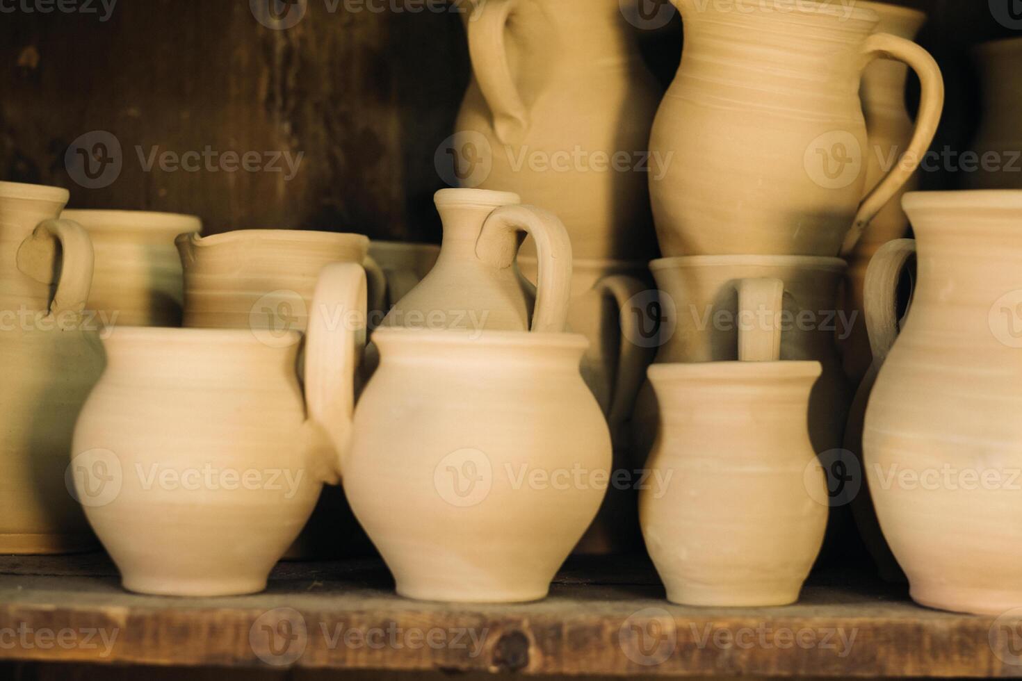 Ceramic clay jugs standing on a shelf in the village photo