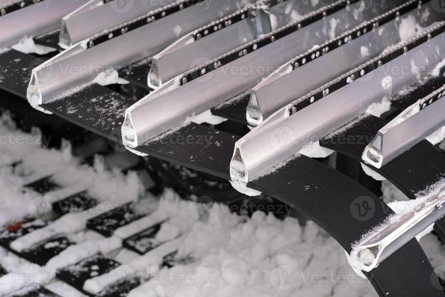 Metal tracks of a snowplow car in winter in the snow photo