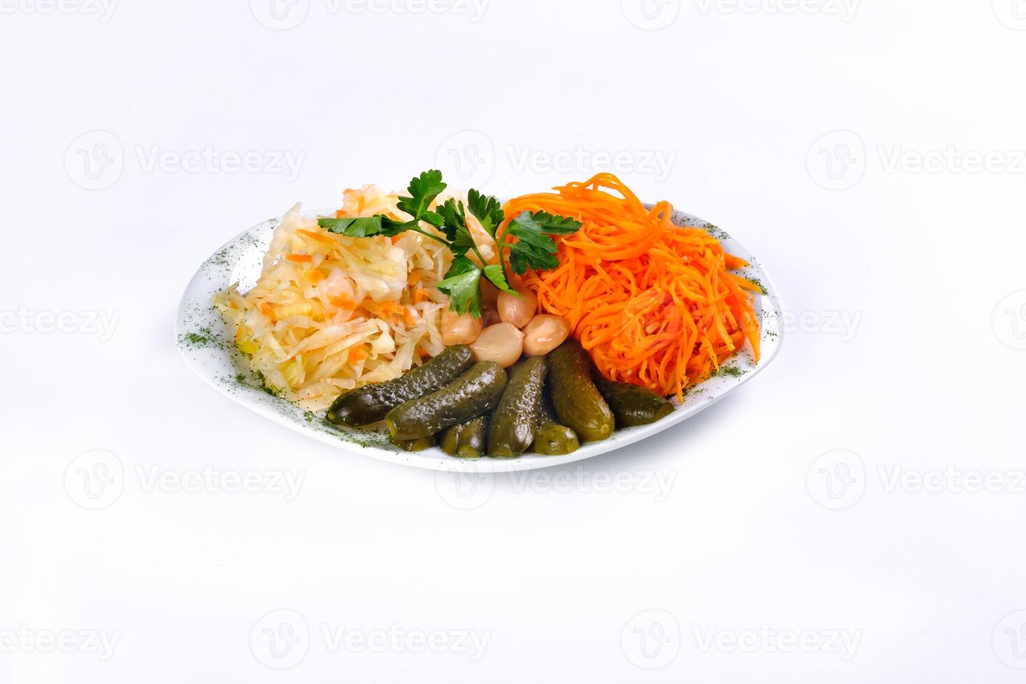 pickled vegetables, cucumber, carrot, garlic, cabbage on a plate on a white isolated background photo