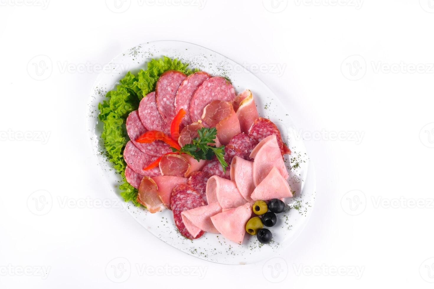 Ham and sausage cut into slices on a plate on a white isolated background photo