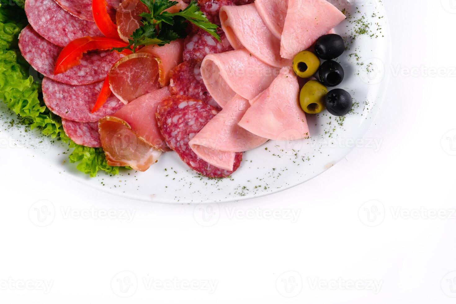 Ham and sausage cut into slices on a plate on a white isolated background photo