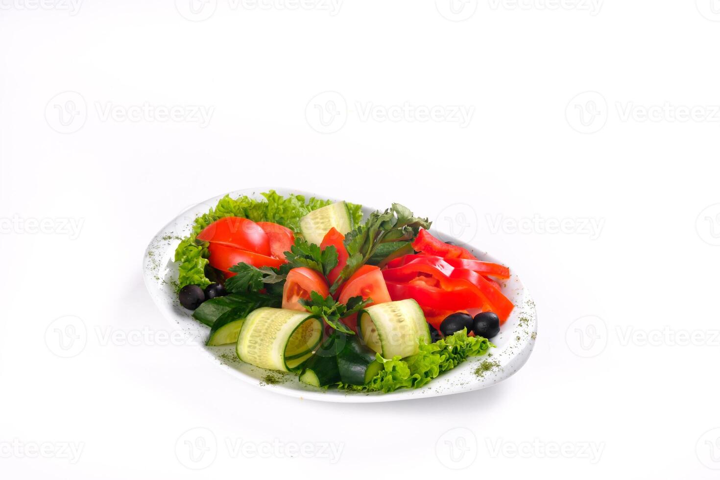 Delicious vegetable salad of tomatoes and cucumbers with olives on a plate on an isolated background photo