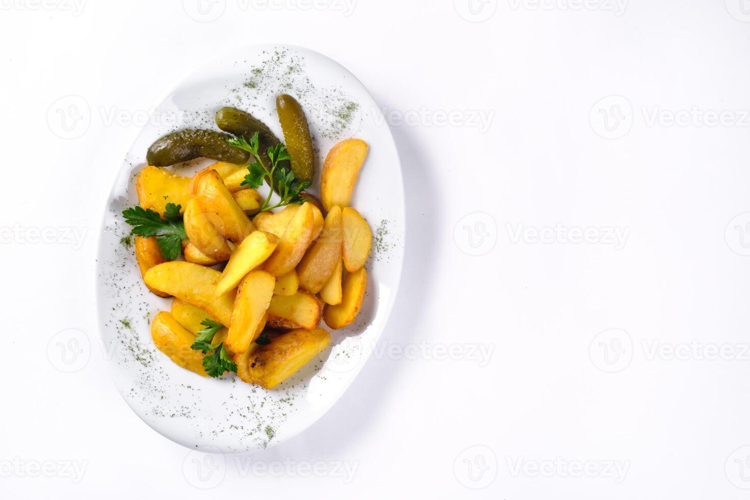 Fried potato slices on a white plate pickled with cucumber, isolated on a white background photo