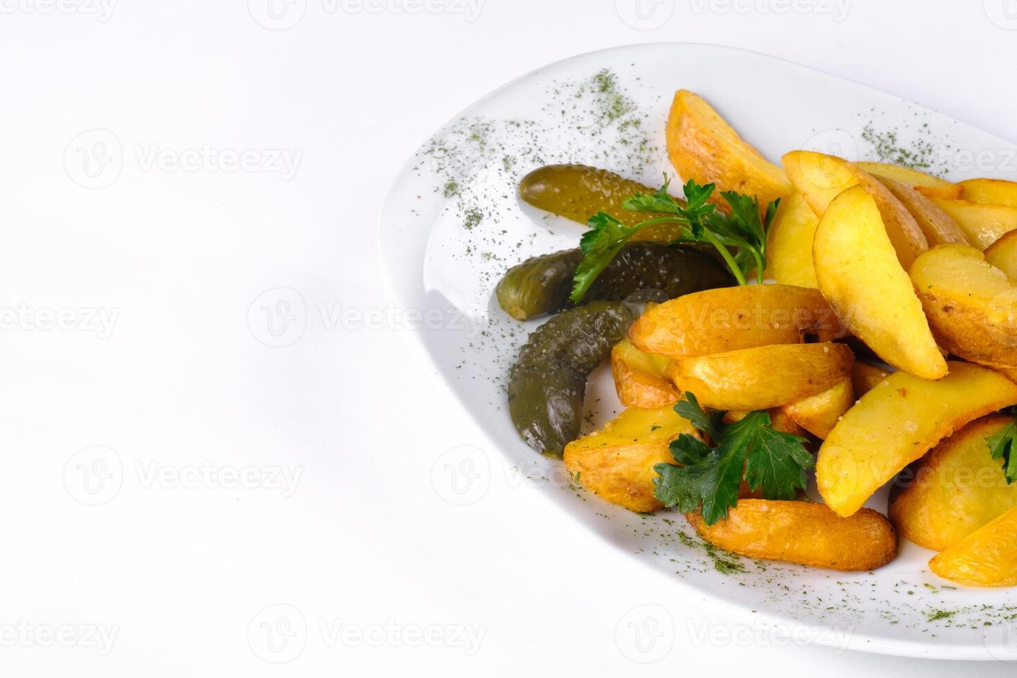 Fried potato slices on a white plate pickled with cucumber, isolated on a white background photo