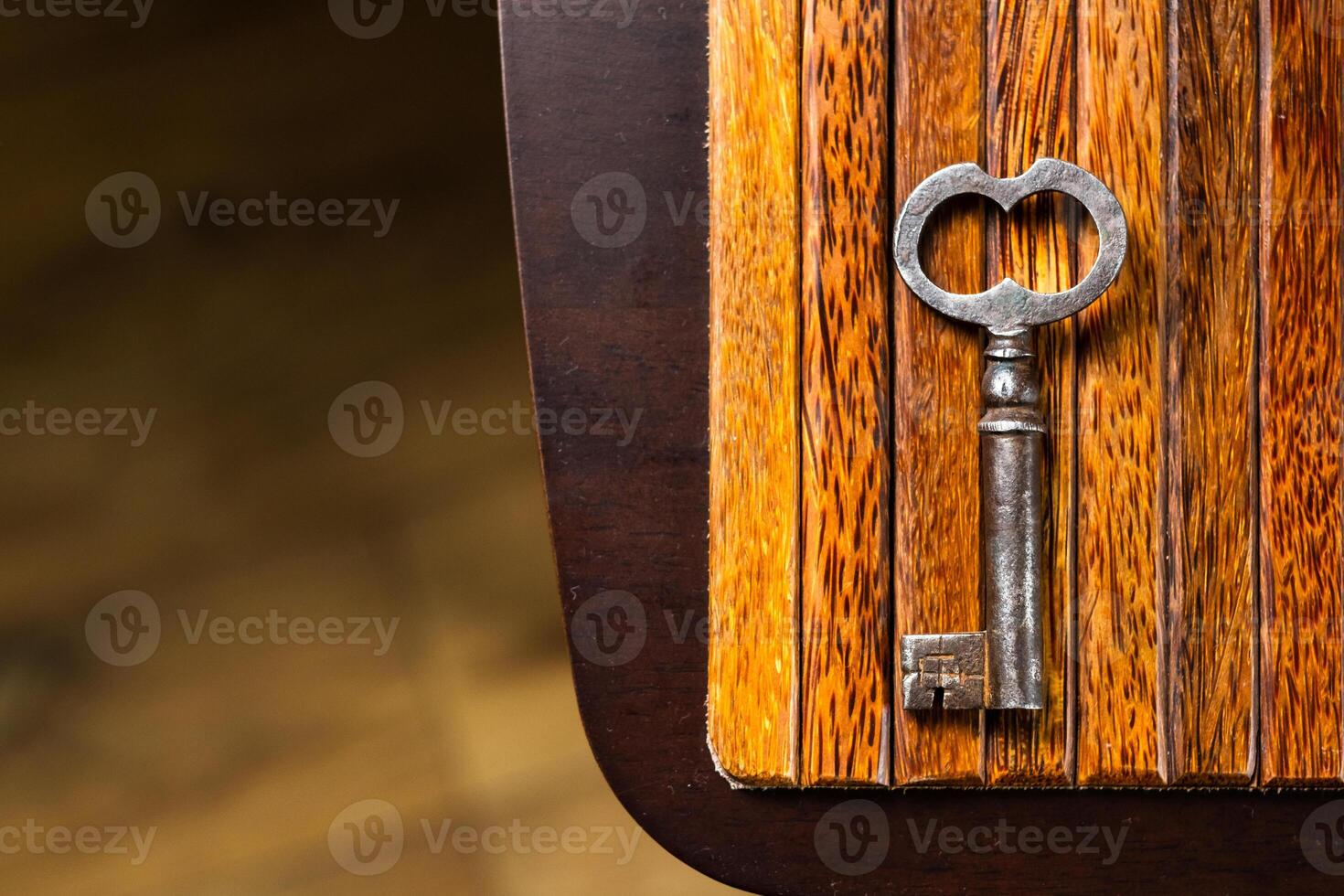 the old key lies on an old wooden table, natural textures, the concept of discoveries, secrets, answers photo