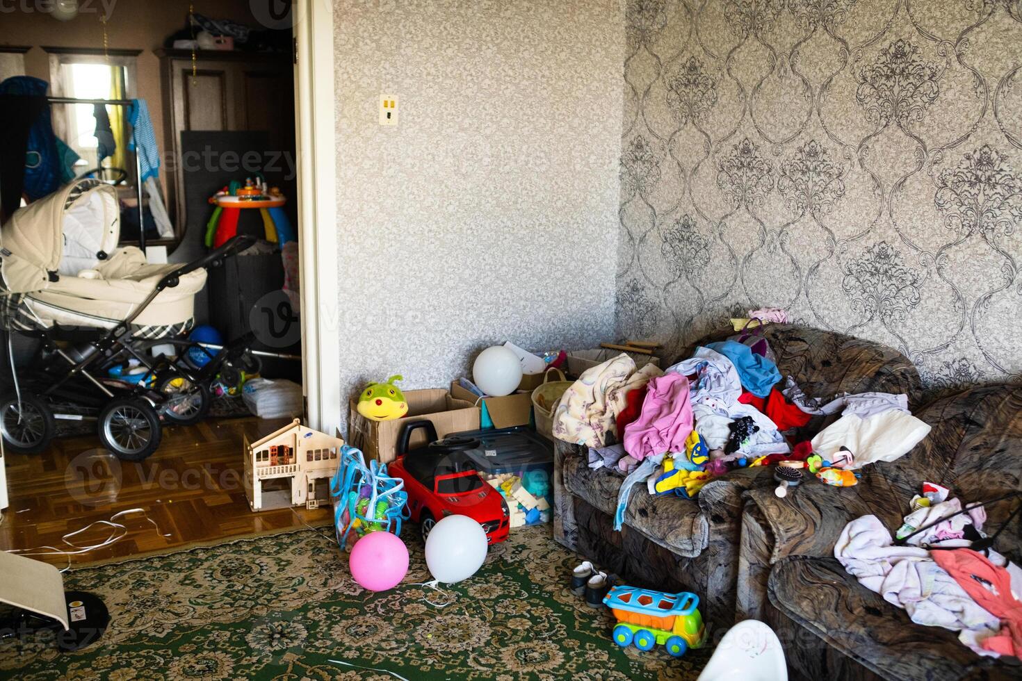 A mess in the room. A lot of things are lying around the apartment. House is in the room photo