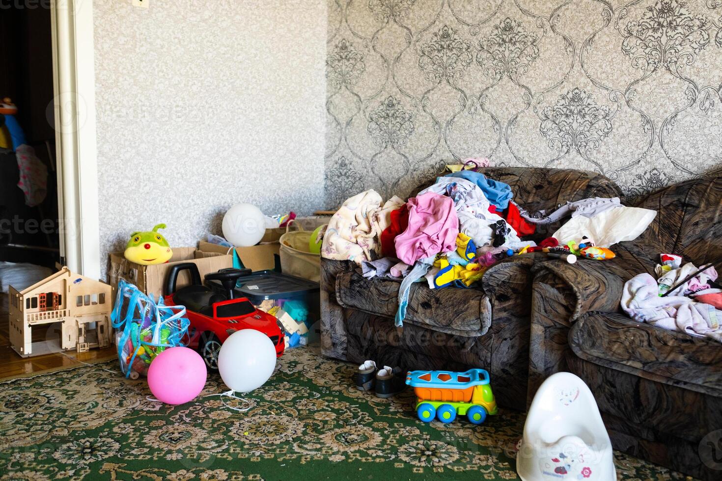 A mess in the room. A lot of things are lying around the apartment. House is in the room photo