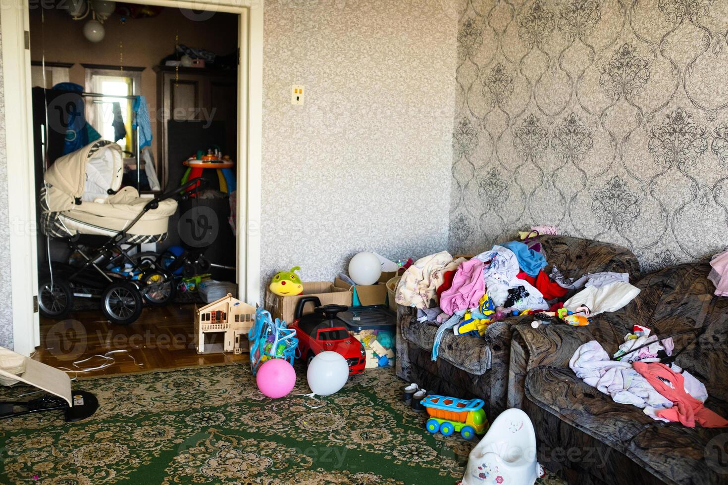 A mess in the room. A lot of things are lying around the apartment. House is in the room photo