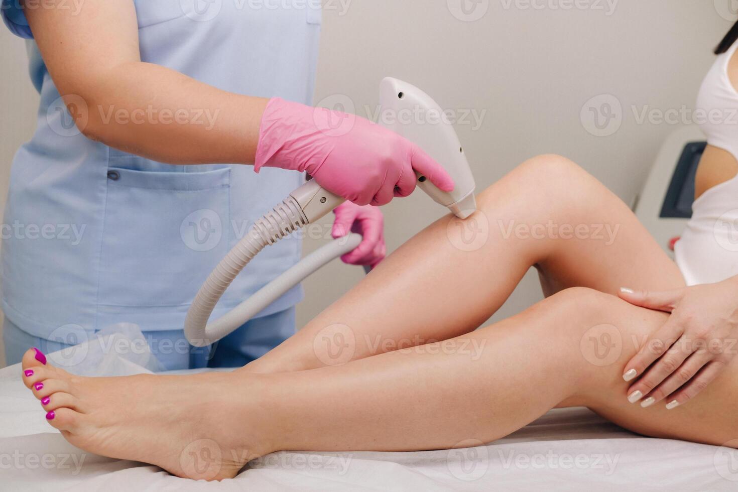 A close-up of the work of a cosmetologist who performs a laser hair removal procedure in the office photo