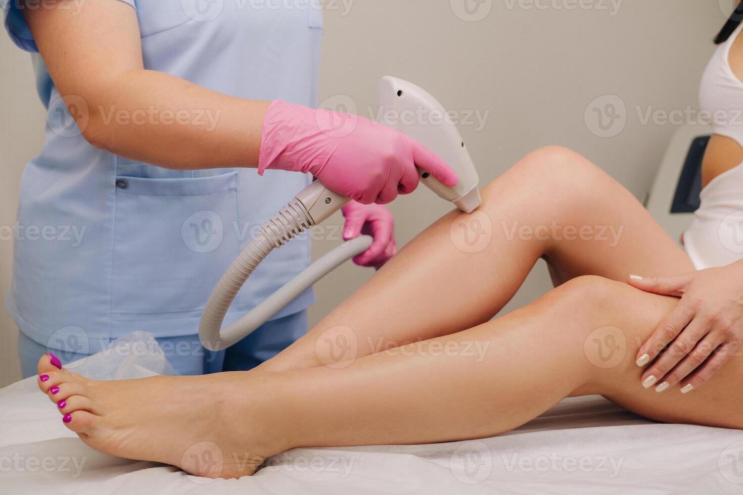 A close-up of the work of a cosmetologist who performs a laser hair removal procedure in the office photo