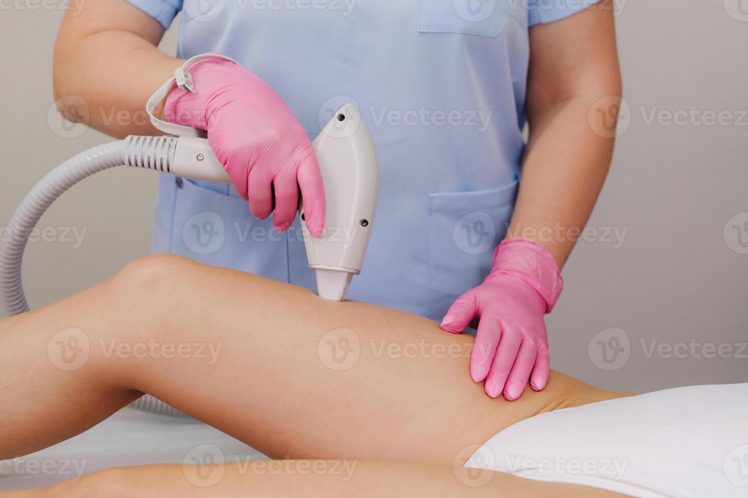 A close-up of the work of a cosmetologist who performs a laser hair removal procedure in the office photo