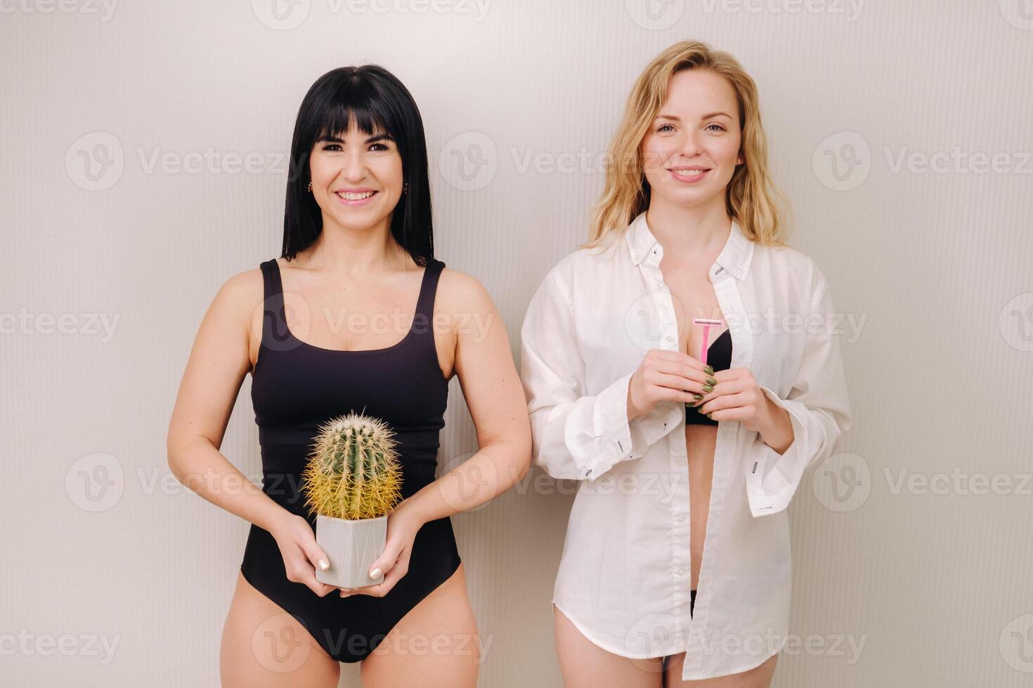 Cactus concept. Unshaven body . One girl is holding a cactus in her hands, and the second girl is holding a razor. Symbol of unshaven body parts photo