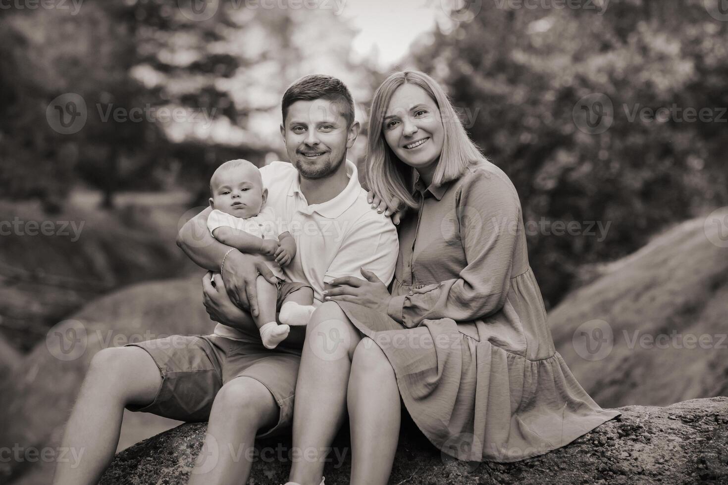 Happy family of three in the summer in the park in nature photo