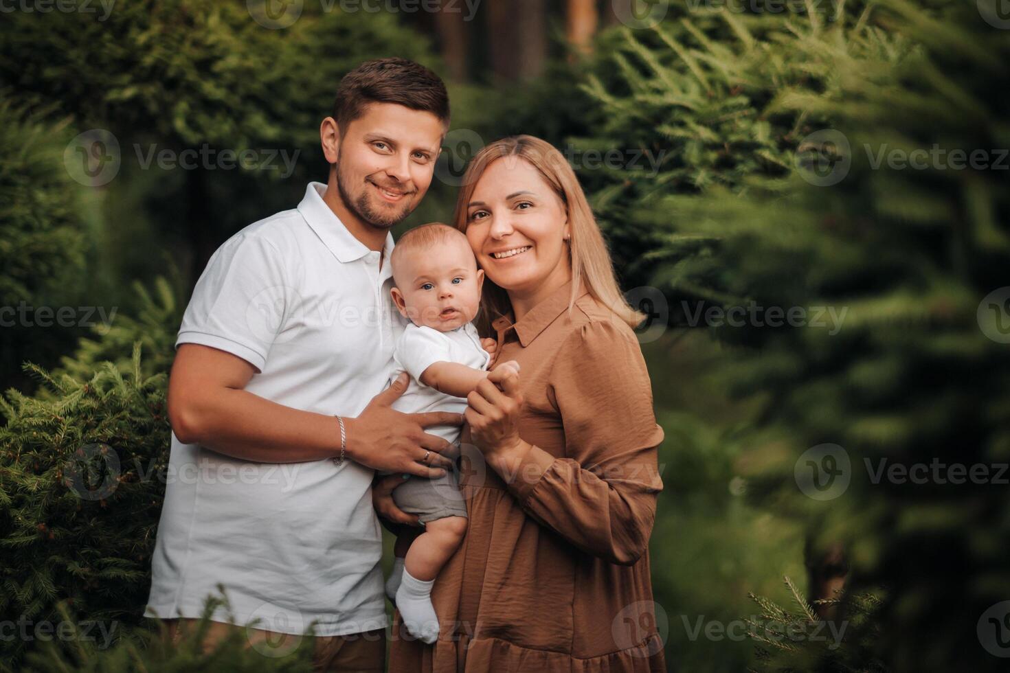 Happy family of three in the summer in the park in nature photo