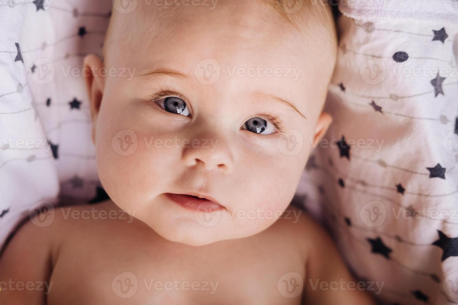 Close-up of the face of a cute baby lying in photo