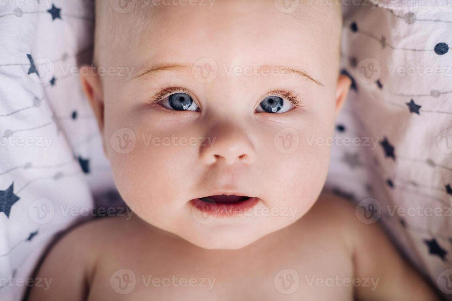 Close-up of the face of a cute baby lying in photo