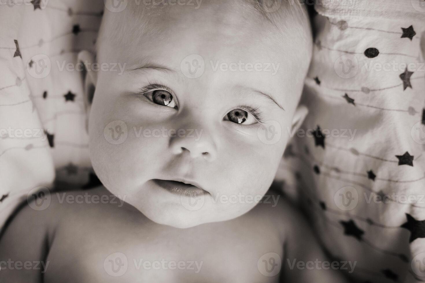 Close-up of the face of a cute baby lying in photo