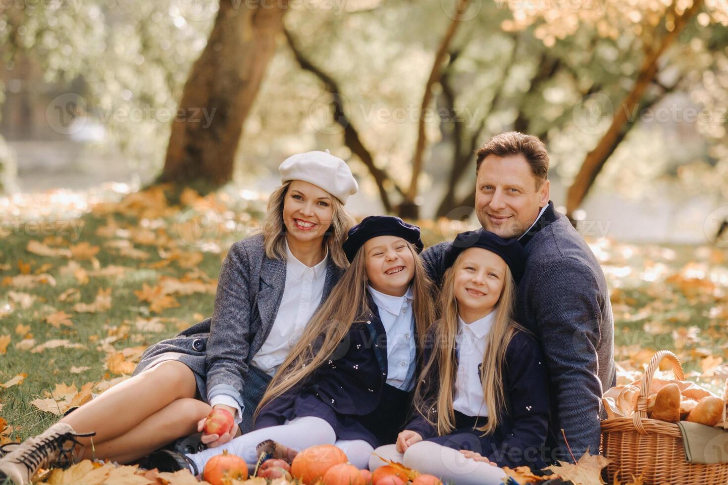 A big family on a picnic in the fall in a nature park. Happy people in the autumn park photo