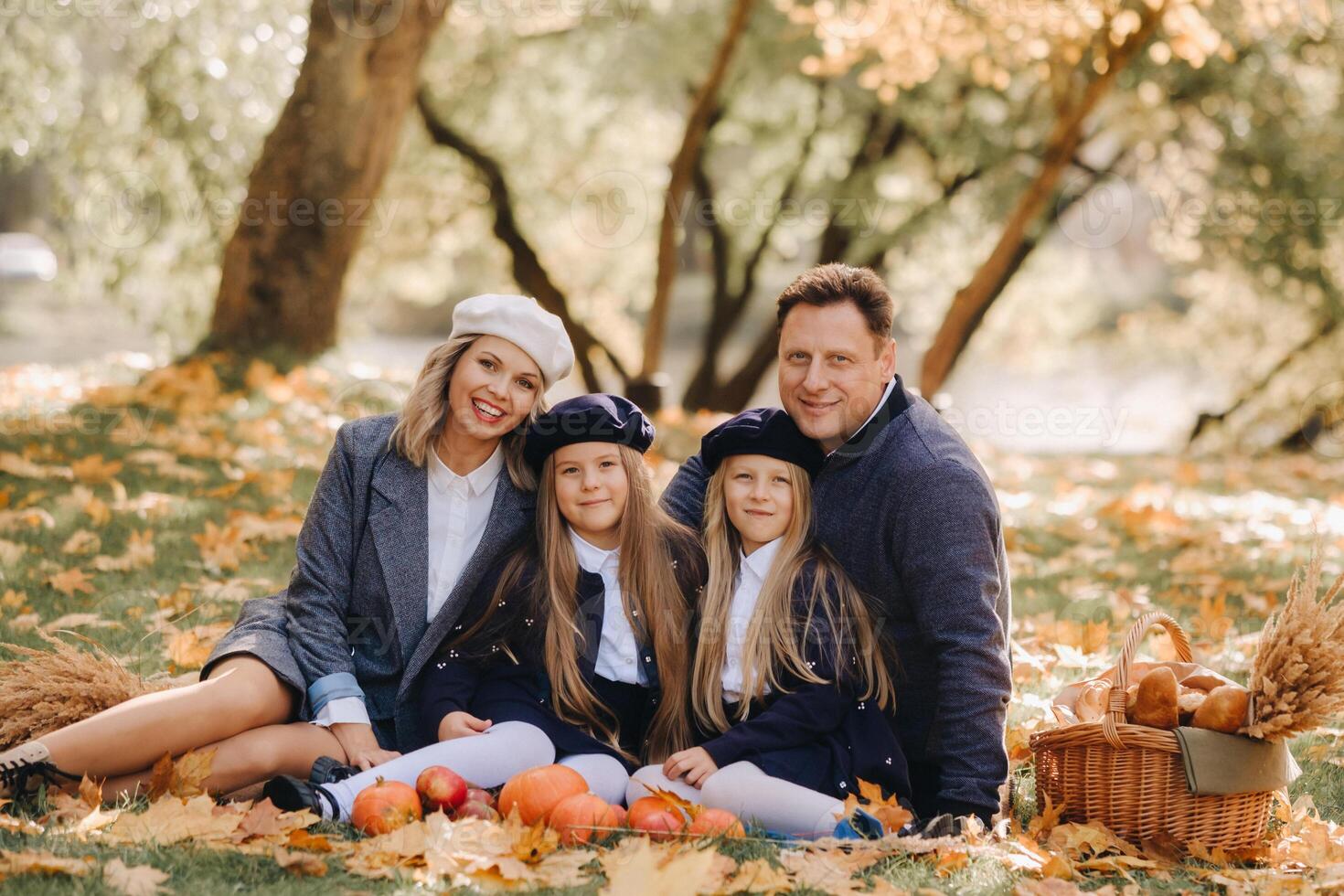 A big family on a picnic in the fall in a nature park. Happy people in the autumn park photo