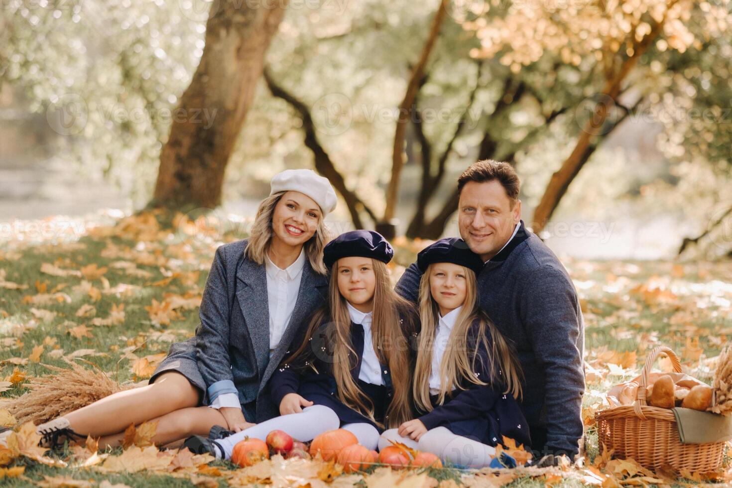 A big family on a picnic in the fall in a nature park. Happy people in the autumn park photo