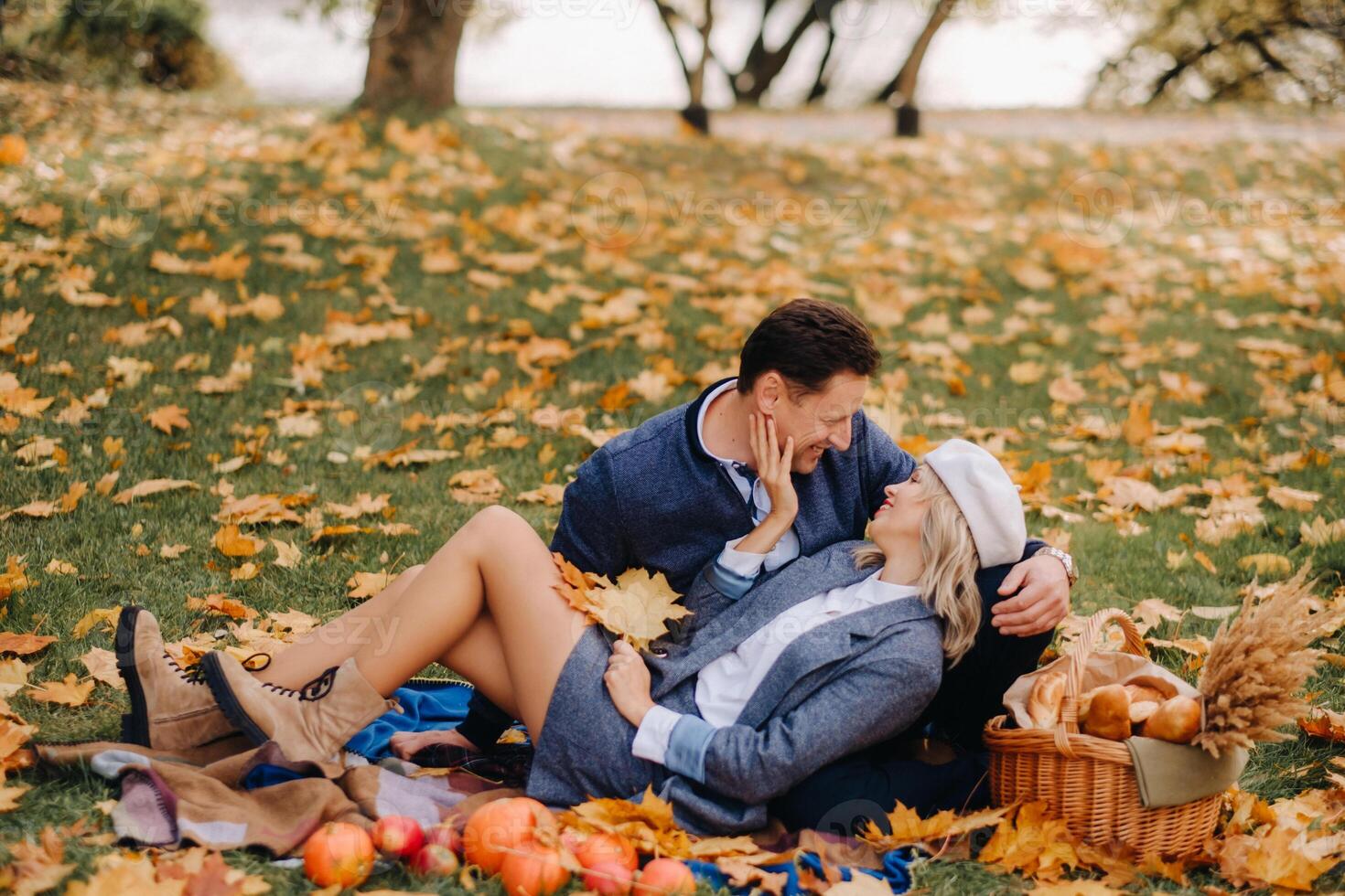 Happy couple enjoying golden autumn spring season in the park photo